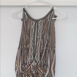 high neck embellished mini dress with dropped hem